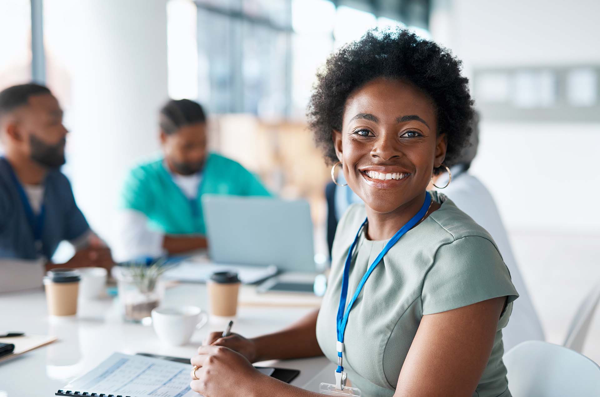 Black woman, portrait or happy doctor in meeting planning a surgery strategy or speaking of medical results in hospital. Teamwork, smile or African healthcare worker consulting, talking or working